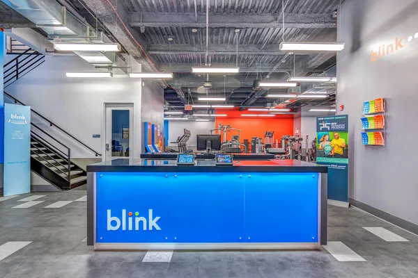 Blink Fitness front desk and lobby in the brand's signature colors