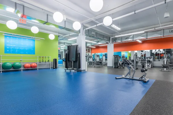 Cardio equipment facing the front windows of a Blink location