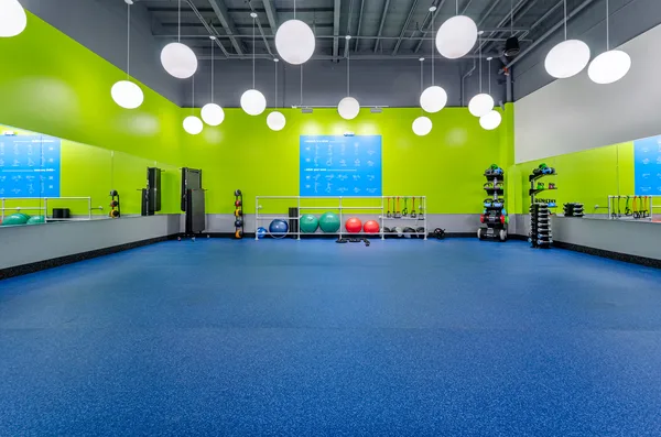 Brand graphics running along a Blink Fitness wall
