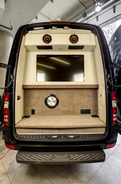 Rear doors of the Mercedes-Benz Sprinter open to reveal the integrated entertainment screen