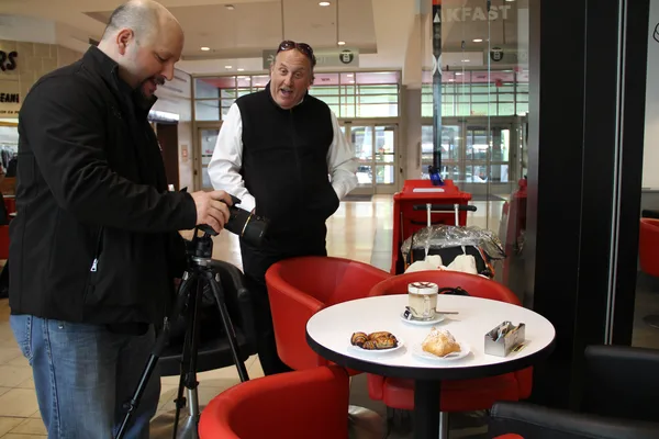 Setting up a tripod-mounted camera for an interior business shoot