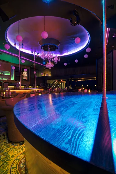 Club bar photographed with backlit shelving aglow