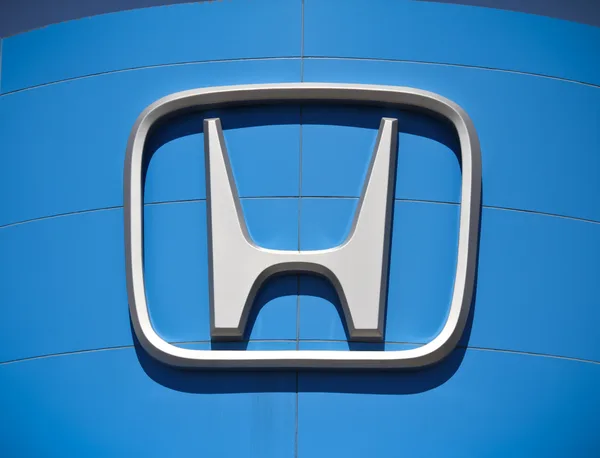 Dealership exterior signage against a clear sky
