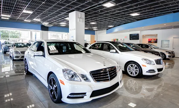 Dusk facades and showroom rows from dealer lots across NJ & NY.