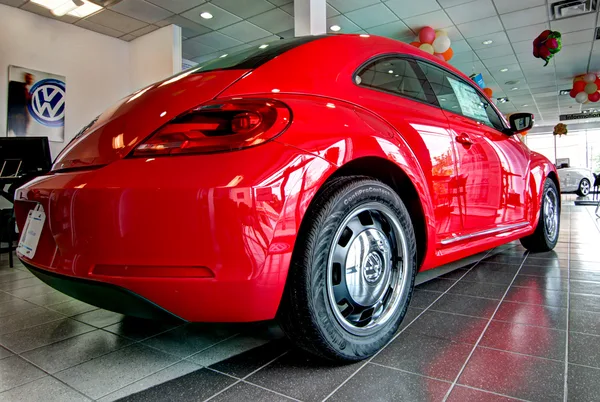 Compact hatchback staged beside the dealership's service entrance