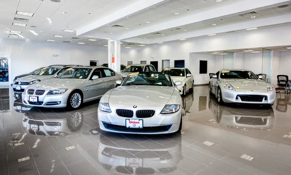 Sales desks arranged along the showroom's glass wall