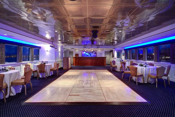 Boat showroom interior with hulls under display lighting