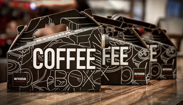 Stacked cups and grinder detail at the barista station