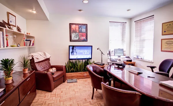 Reception area with the firm's name mounted behind the desk