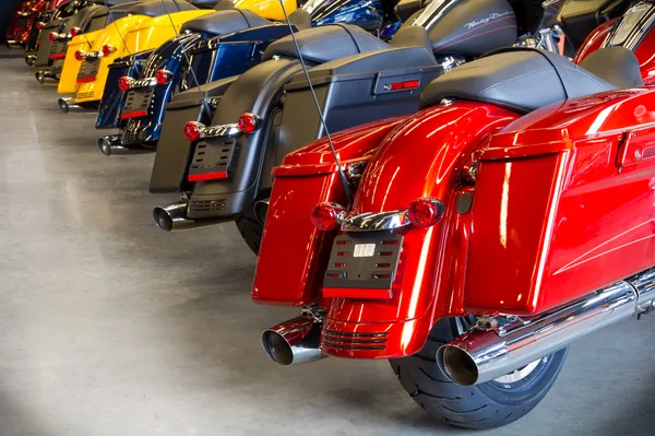 Showroom rows of motorcycles receding toward the service counter