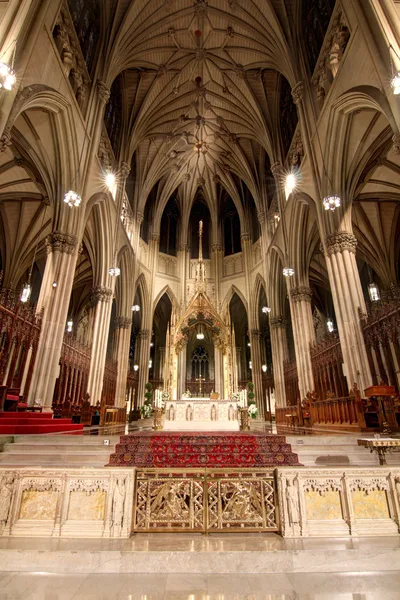 Evening exterior with the church windows lit from within